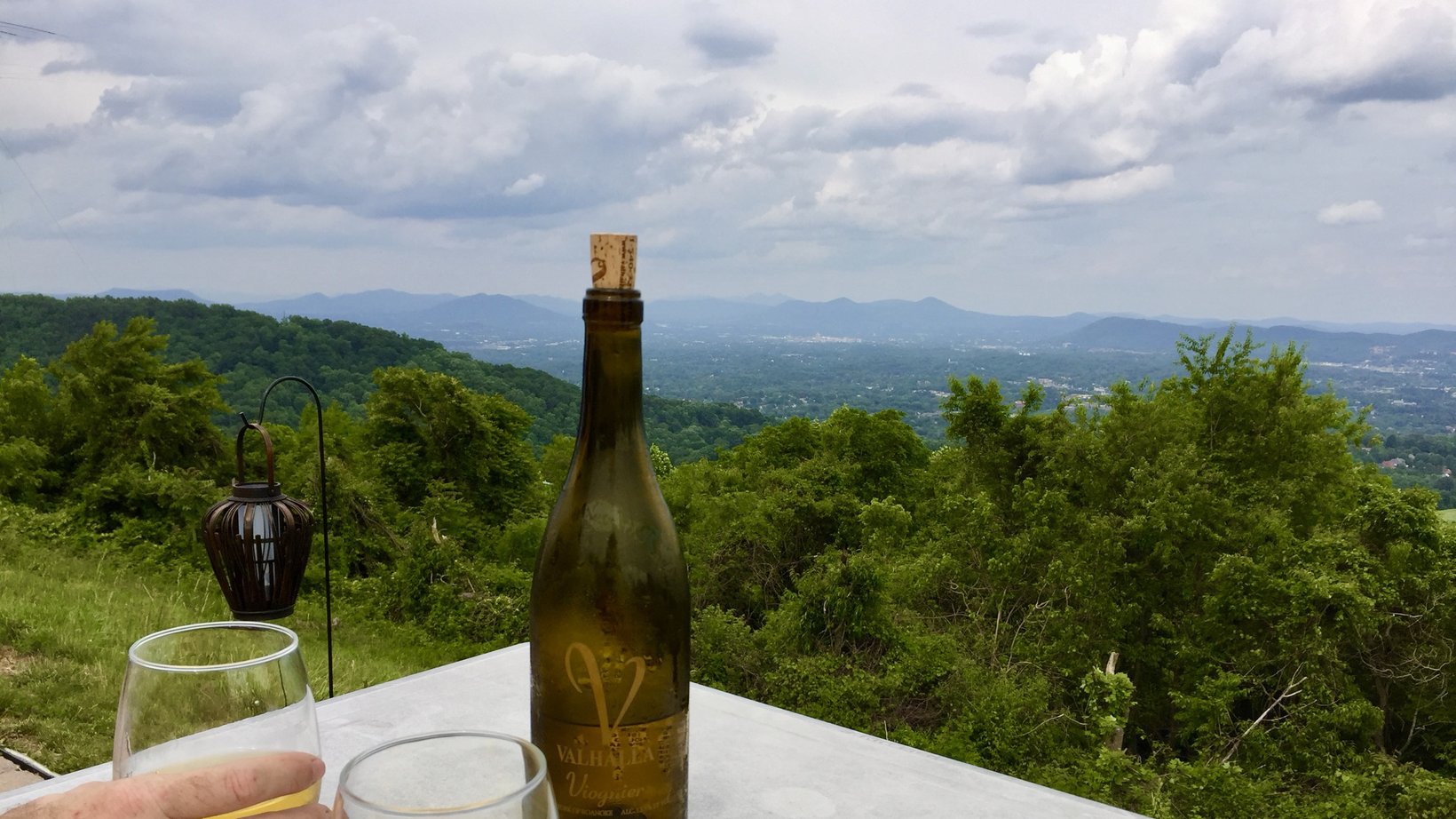 A table with wine looking out over the Blue Ridge Mountains