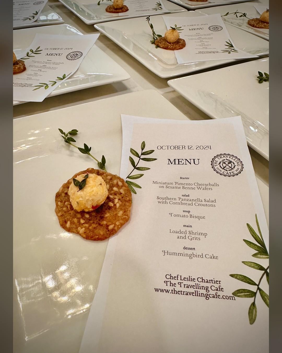 A printed custom menu card beside a pimento cheese starter