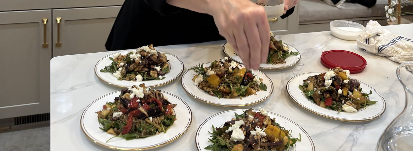 A Travelling Cafe chef finishing plated salads