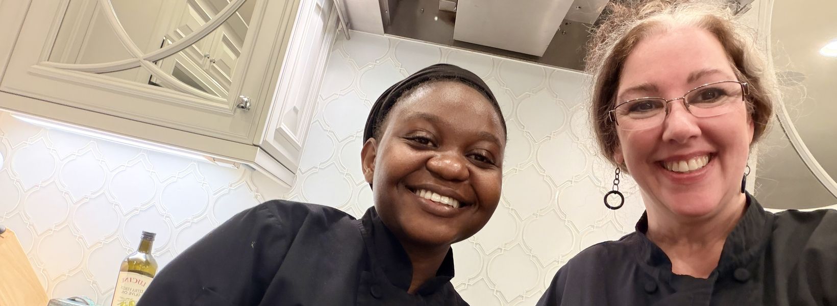 Two Travelling Cafe chefs in a client's kitchen