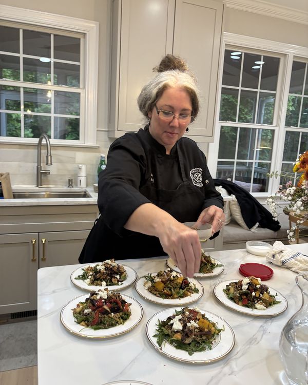 A Travelling Cafe chef plating salads