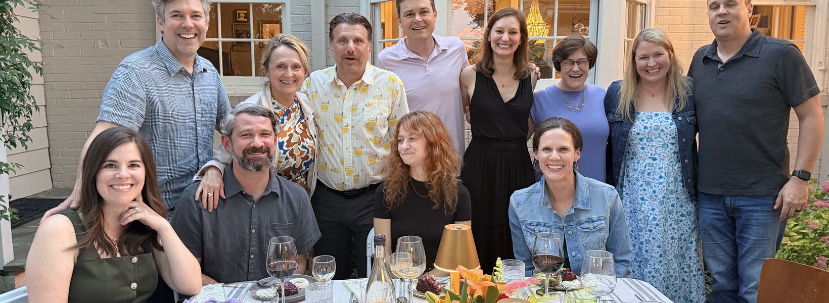 Guests around a dinner party table with a Travelling Cafe chef