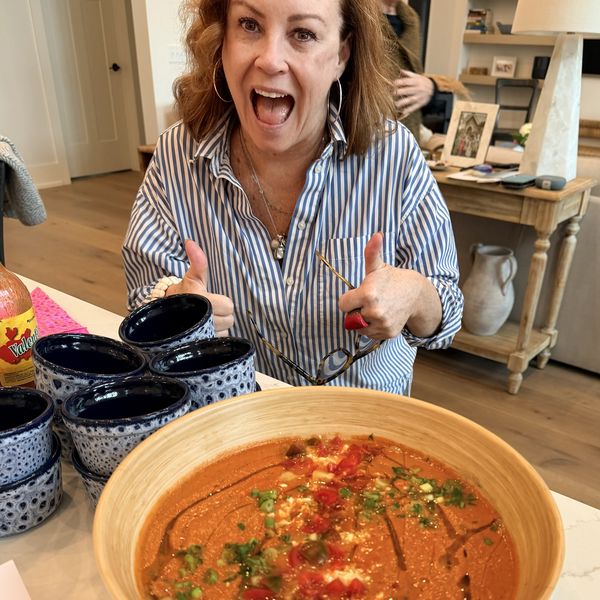 A happy guest with a big bowl of gazpacho