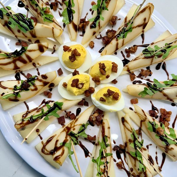 A pear and deviled egg platter with balsamic