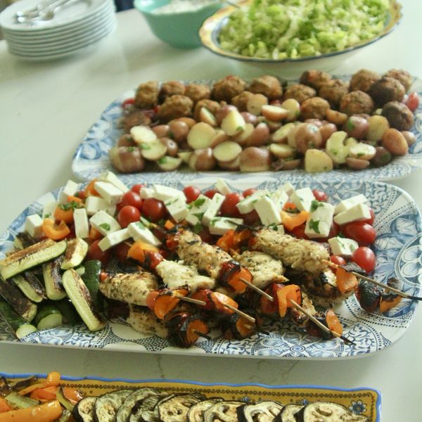 Grilled skewers and vegetables on platters